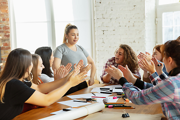 Image showing Young people discussing about women rights and equality at the office