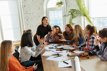 Image showing Young people discussing about women rights and equality at the office