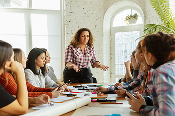 Image showing Young people discussing about women rights and equality at the office