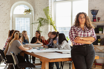 Image showing Young people discussing about women rights and equality at the office