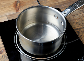 Image showing kettle of water on electric induction hob