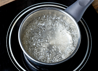 Image showing kettle of boiling water on electric induction hob