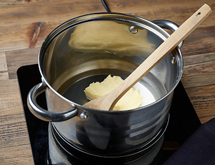 Image showing water and butter in a pot