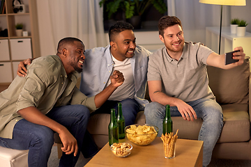 Image showing male friends with smartphone taking selfie at home