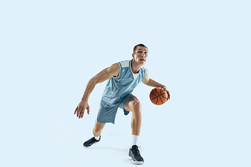 Image showing Young caucasian basketball player against white studio background