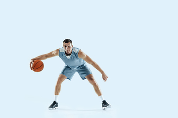 Image showing Young caucasian basketball player against white studio background