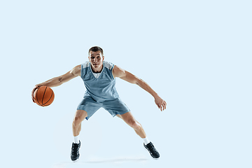 Image showing Young caucasian basketball player against white studio background