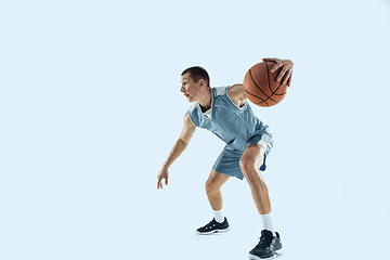 Image showing Young caucasian basketball player against white studio background