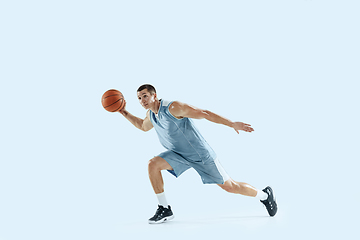 Image showing Young caucasian basketball player against white studio background