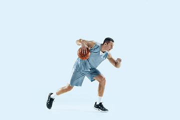 Image showing Young caucasian basketball player against white studio background