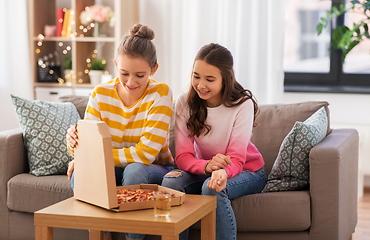 Image showing happy teenage girls eating takeaway pizza at home