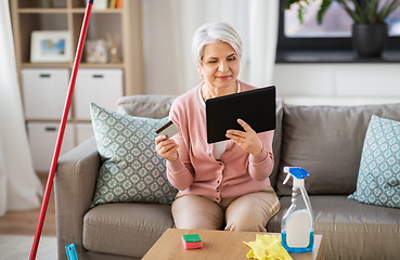 Image showing old woman with tablet pc and credit card at home