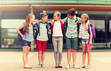 Image showing group of happy elementary school students hugging