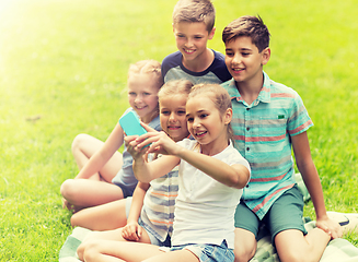 Image showing happy kids or friends taking selfie in summer park