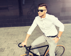 Image showing man with bicycle and headphones on city street