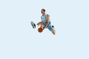 Image showing Young caucasian basketball player against white studio background