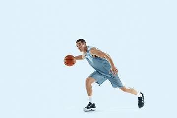 Image showing Young caucasian basketball player against white studio background