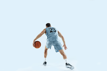 Image showing Young caucasian basketball player against white studio background