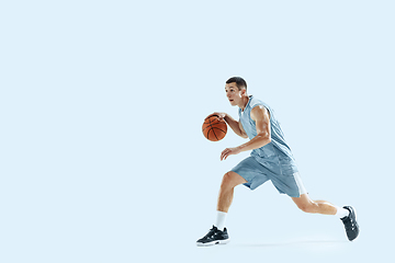 Image showing Young caucasian basketball player against white studio background