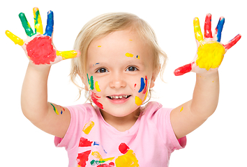 Image showing Portrait of a cute little girl playing with paints