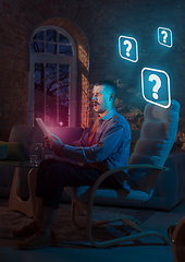 Image showing Man using gadget and receive neon notifications at home at night