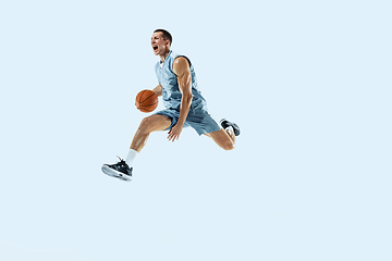 Image showing Young caucasian basketball player against white studio background