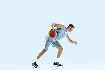 Image showing Young caucasian basketball player against white studio background