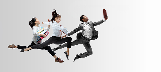 Image showing Office workers or ballet dancers jumping on white background