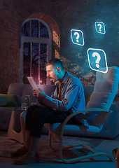 Image showing Man using gadget and receive neon notifications at home at night