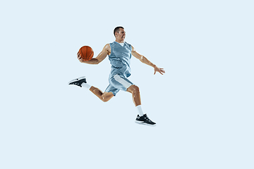 Image showing Young caucasian basketball player against white studio background