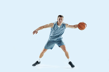 Image showing Young caucasian basketball player against white studio background