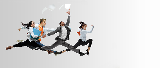 Image showing Office workers or ballet dancers jumping on white background