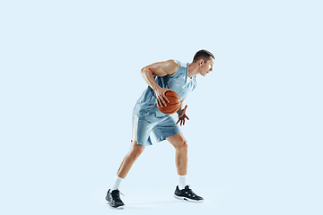 Image showing Young caucasian basketball player against white studio background