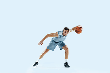 Image showing Young caucasian basketball player against white studio background