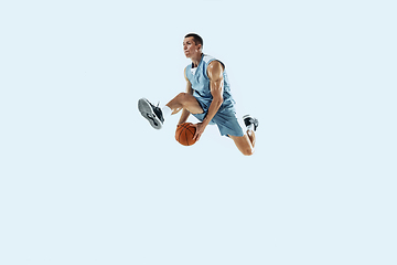 Image showing Young caucasian basketball player against white studio background