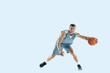 Image showing Young caucasian basketball player against white studio background