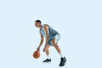 Image showing Young caucasian basketball player against white studio background