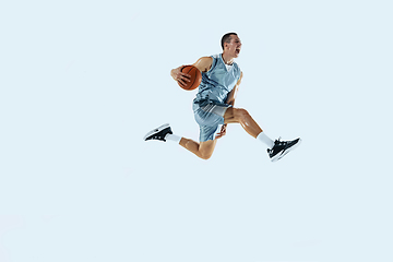 Image showing Young caucasian basketball player against white studio background