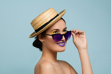 Image showing Portrait of beautiful young woman with bright make-up isolated on blue studio background