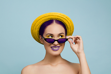 Image showing Portrait of beautiful young woman with bright make-up isolated on blue studio background