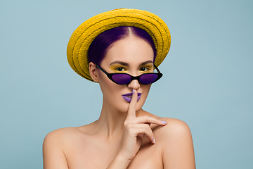 Image showing Portrait of beautiful young woman with bright make-up isolated on blue studio background