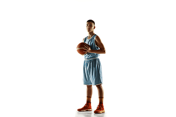 Image showing Full length portrait of a young basketball player with ball