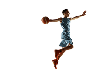 Image showing Full length portrait of a young basketball player with ball