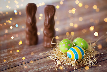 Image showing easter eggs in straw nest and chocolate bunnies