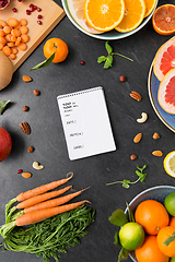 Image showing close up of notebook, fruits and vegetables