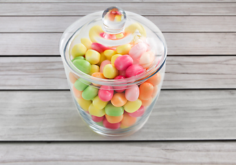 Image showing close up of glass jar with colorful candy drops