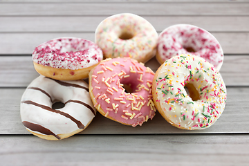 Image showing close up of glazed donuts on wooden boards