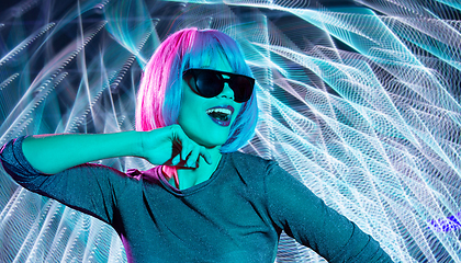 Image showing happy woman in pink wig and black sunglasses