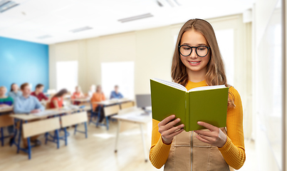 Image showing teenage student girl in glasses reading book