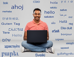 Image showing happy indian man with laptop computer on floor